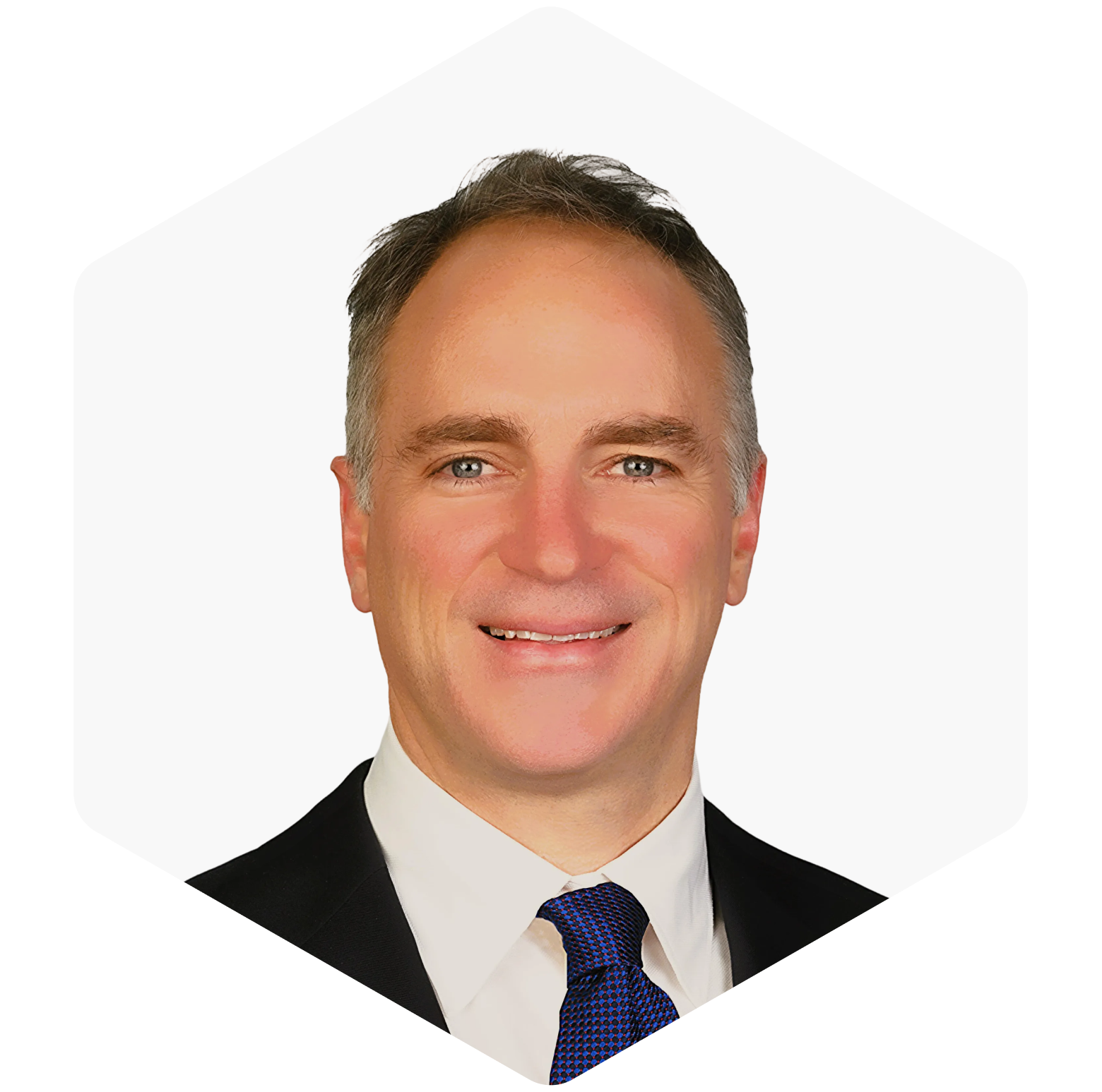 Portrait of a smiling man in a suit and tie, set against a transparent background.