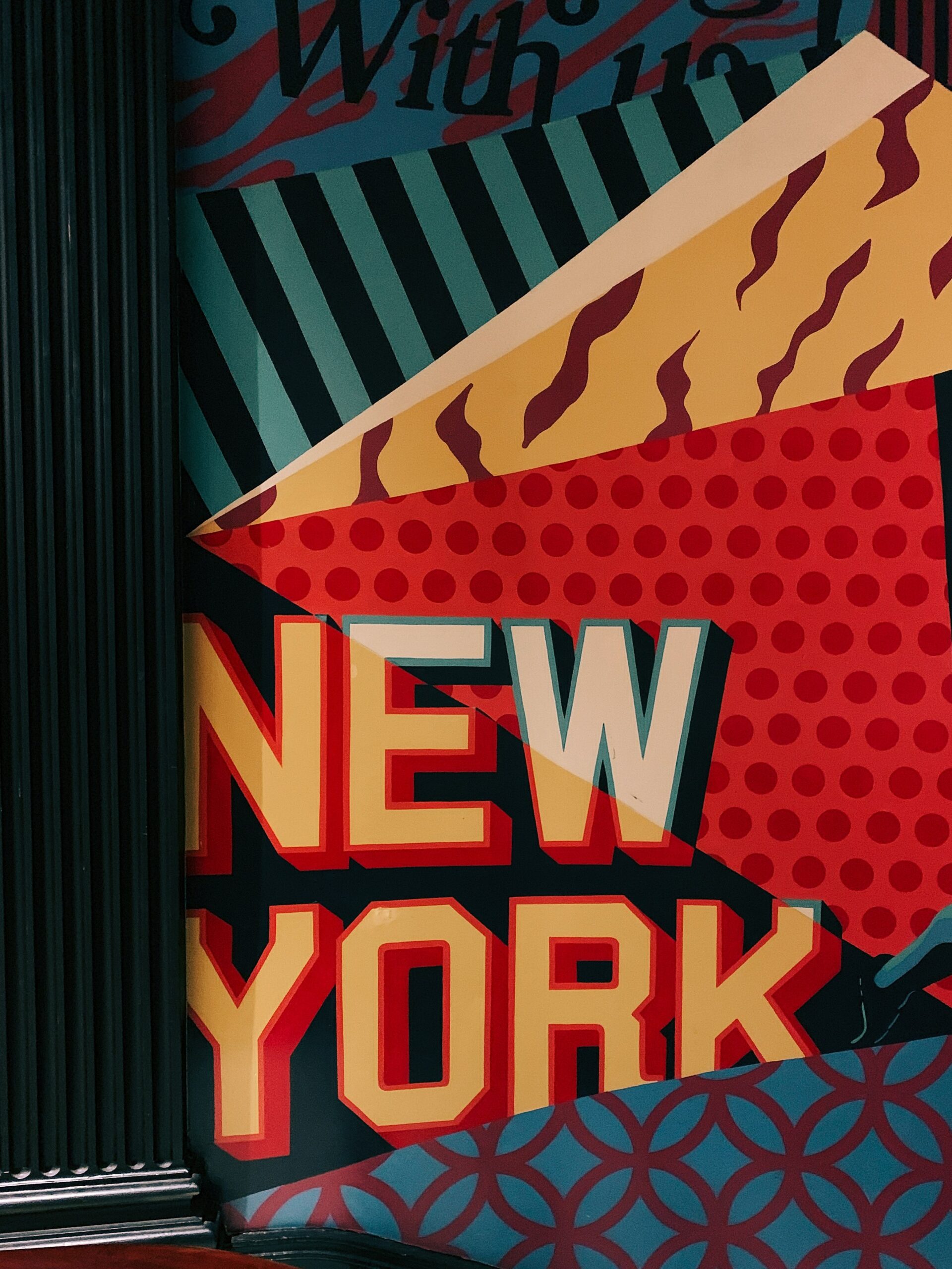 Colorful New York mural with graphic patterns and bold text.